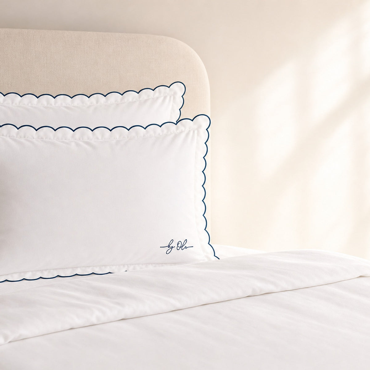 White pillowcases with scalloped edges on a bed