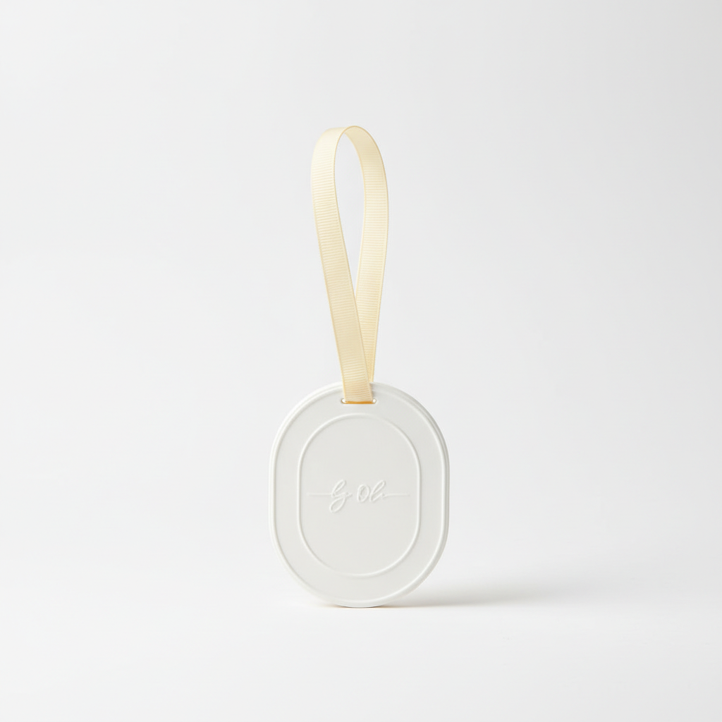Round white soap with a beige strap on a light gray background