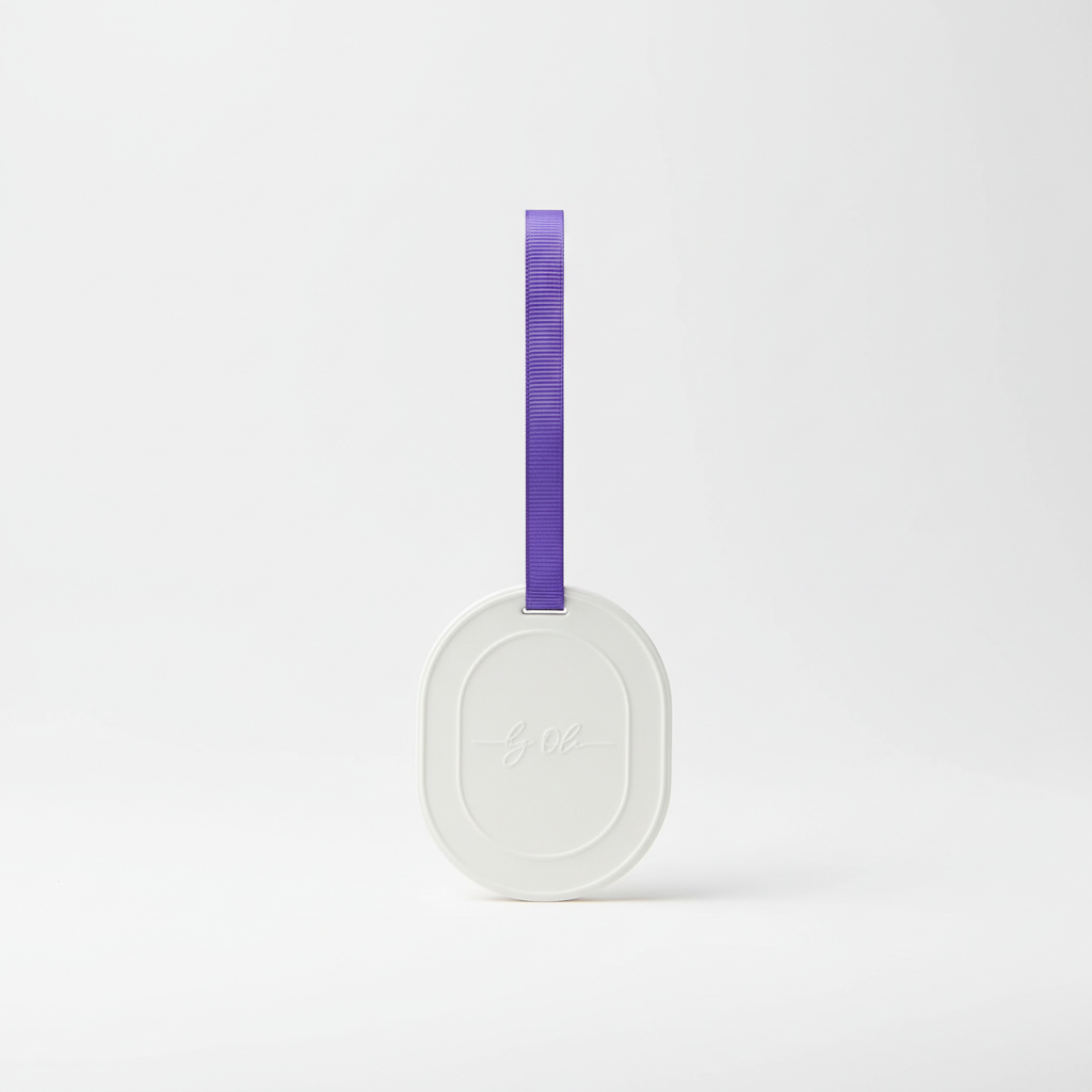 Round scented tablet with a purple strap on a light gray background