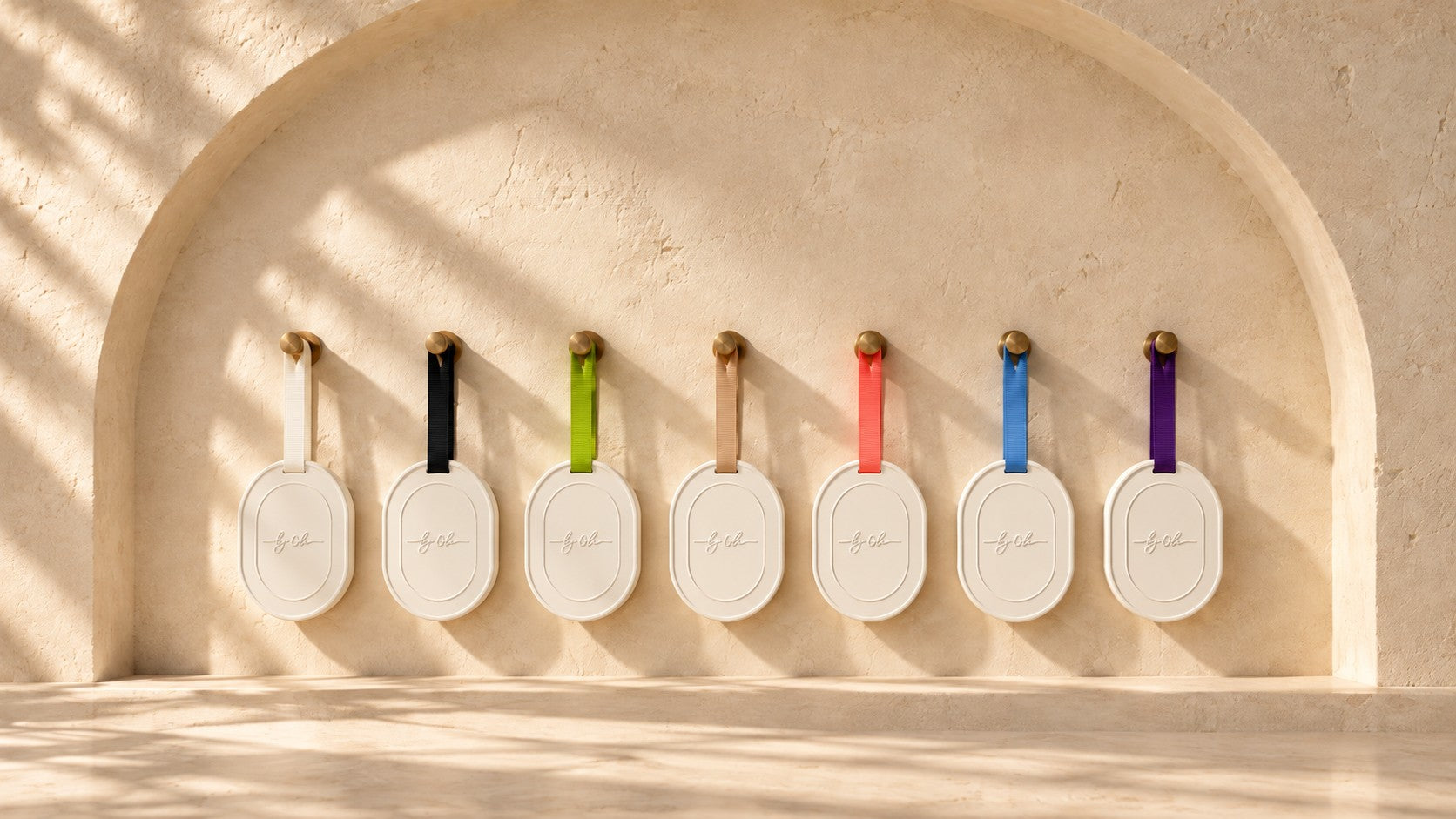Seven white Maison by Ola scented tablets hanging in a sunlit arched niche